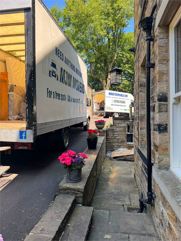 MJM Movers removal truck loading at a customer's home