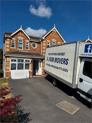 MJM Movers van outside a home during a real house removal