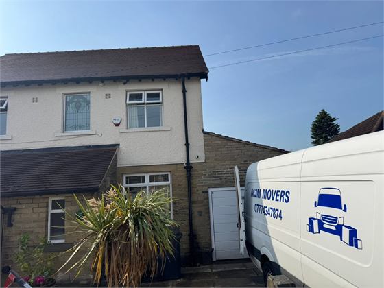 MJM Movers van outside a customer's home during a smaller move